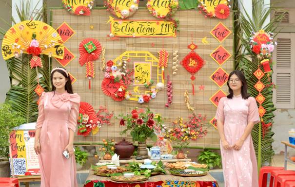 Description: Two women standing in front of a table with food Description automatically generated