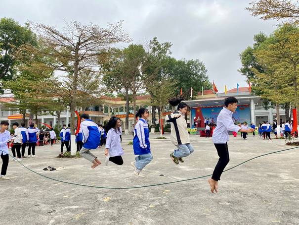 Description: A group of people jumping on a rope Description automatically generated